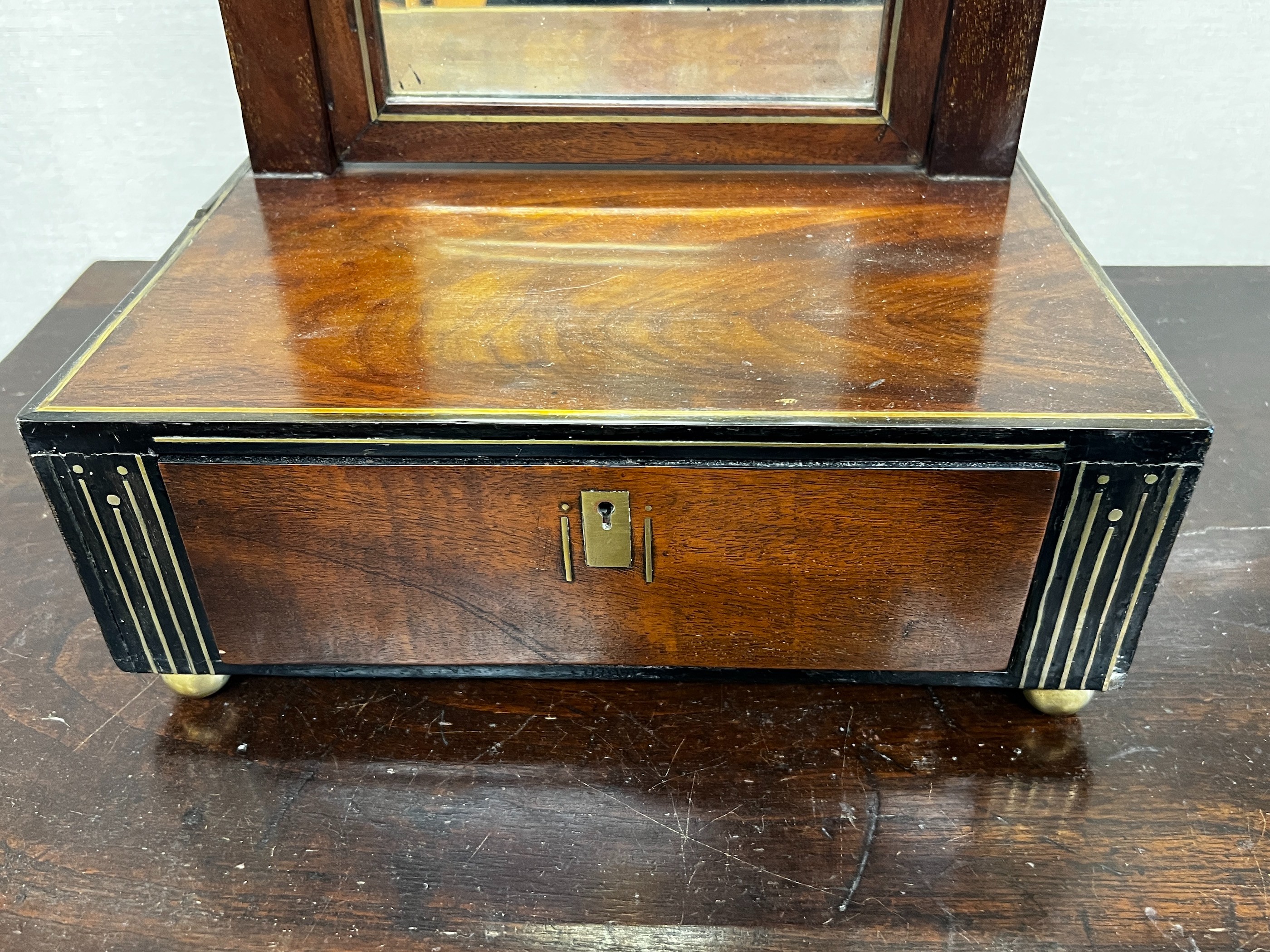 A 19th century German secessionist brass inlaid mahogany toilet mirror, width 34cm, depth 28cm, height 52cm